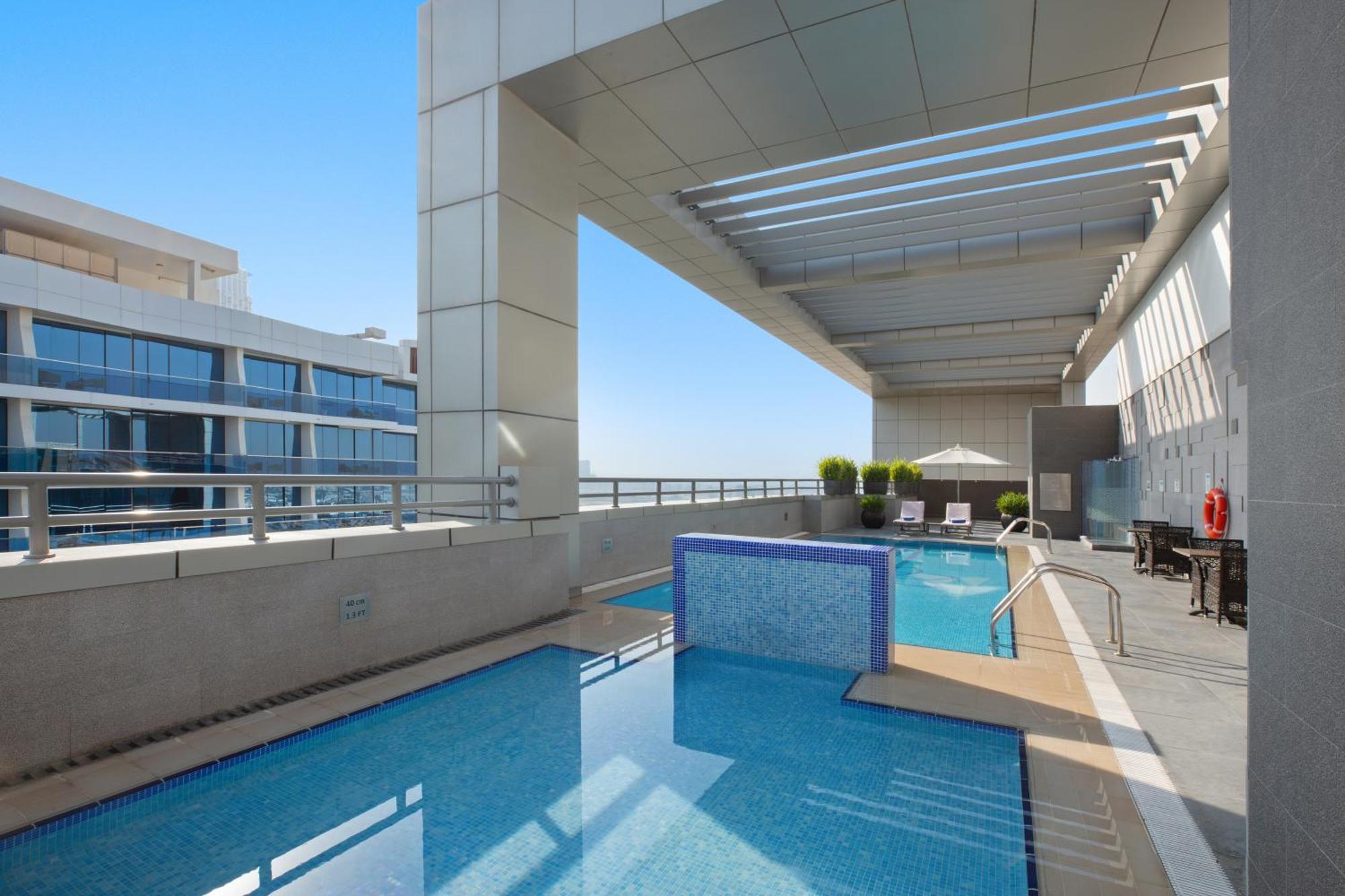 Royal Continental Suites Business Bay Dubai Exterior photo The swimming pool at the top of the hotel